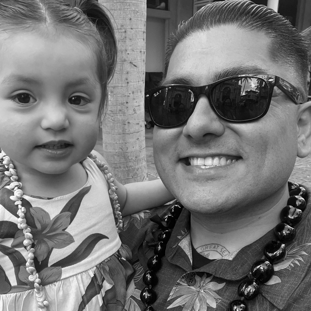 Black-and-white photograph of an adult holding a young child.
